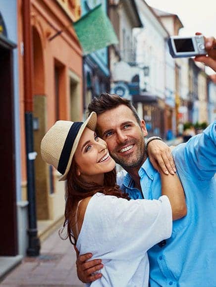 man and woman taking a selfie on vacation