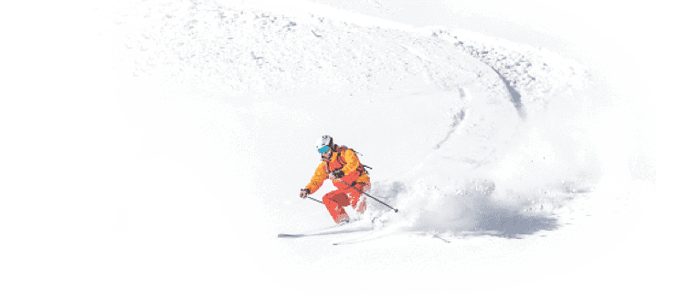 Person skiing downhill on a snowy mountain, showcasing travel experiences available through arrivia's travel loyalty platform