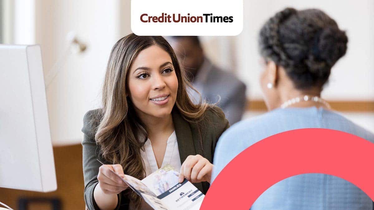 Women learning about her credit union’s travel rewards and benefits program