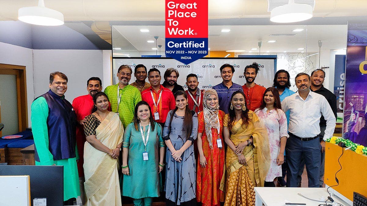 Arrivia India team members standing at their workplace which has been recertified for the 3rd consecutive year as a Great Place to Work