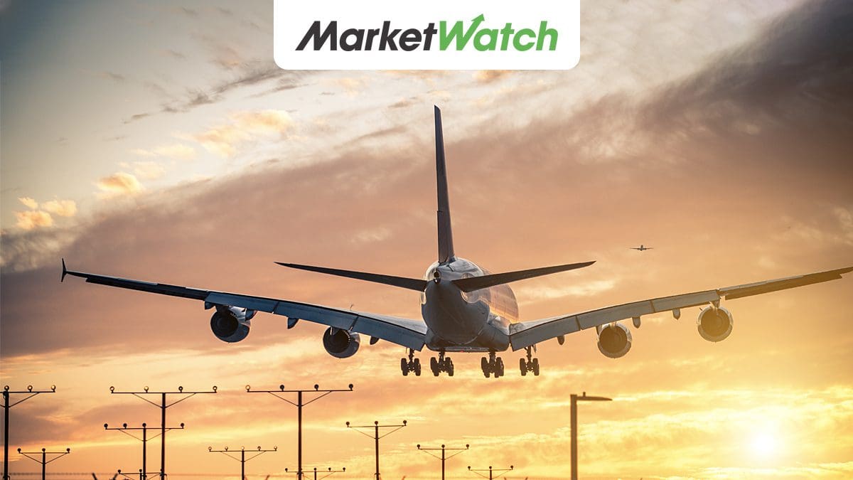 airlines best travel rewards featured image - plane landing into the sunset with MarketWatch logo