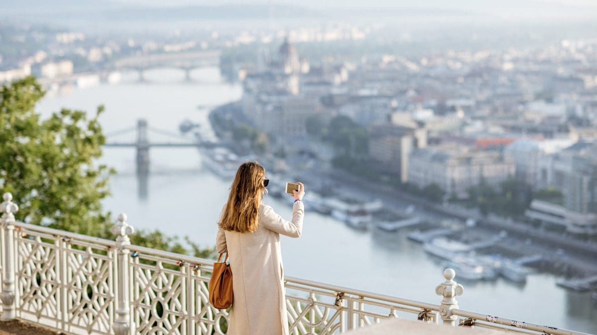 Woman traveling in Budapest using travel rewards benefits.
