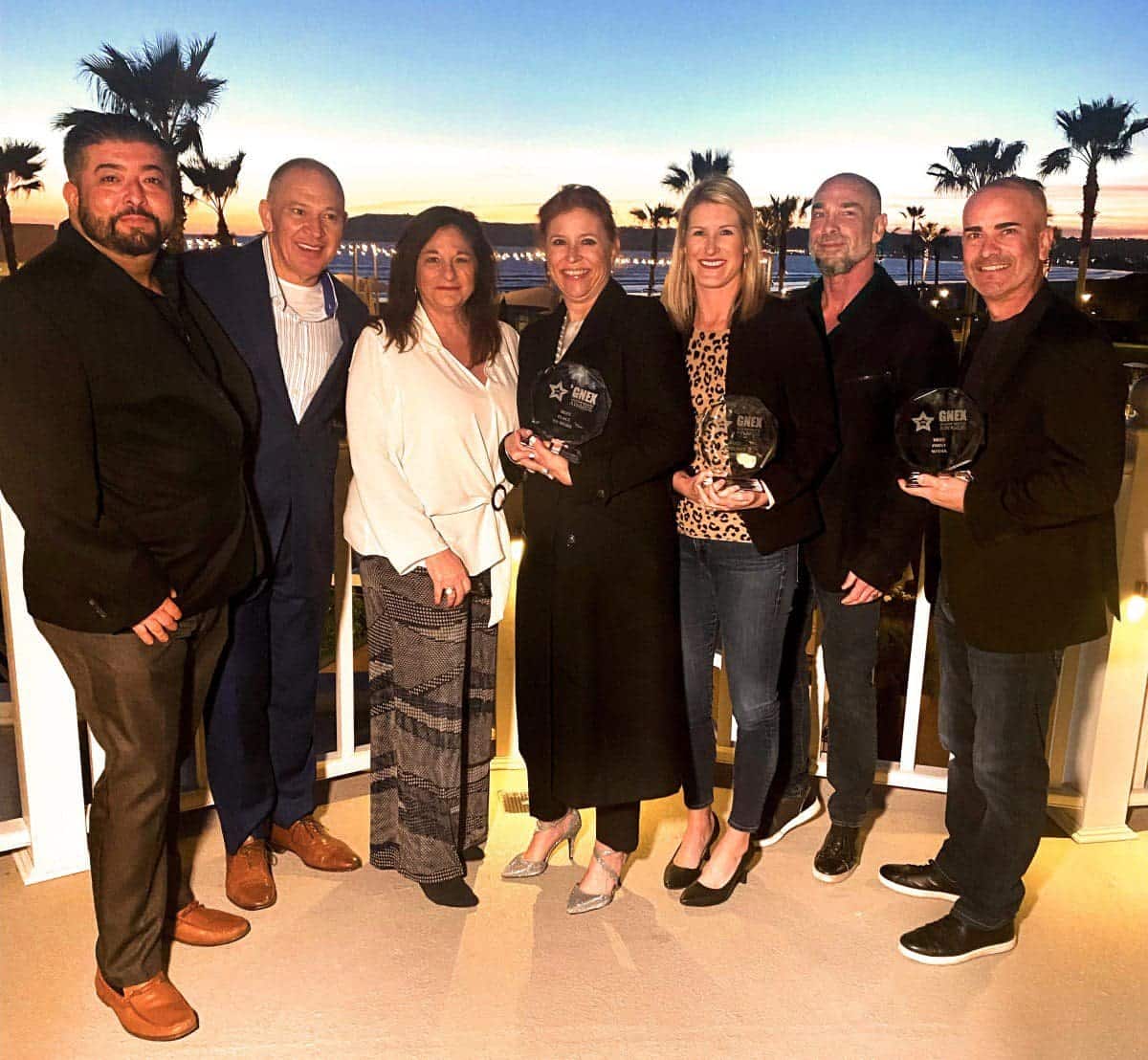 Arrivia’s resort and business development team holding the 3 industry awards they won at the 2023 GNEX Vacation Industry Awards