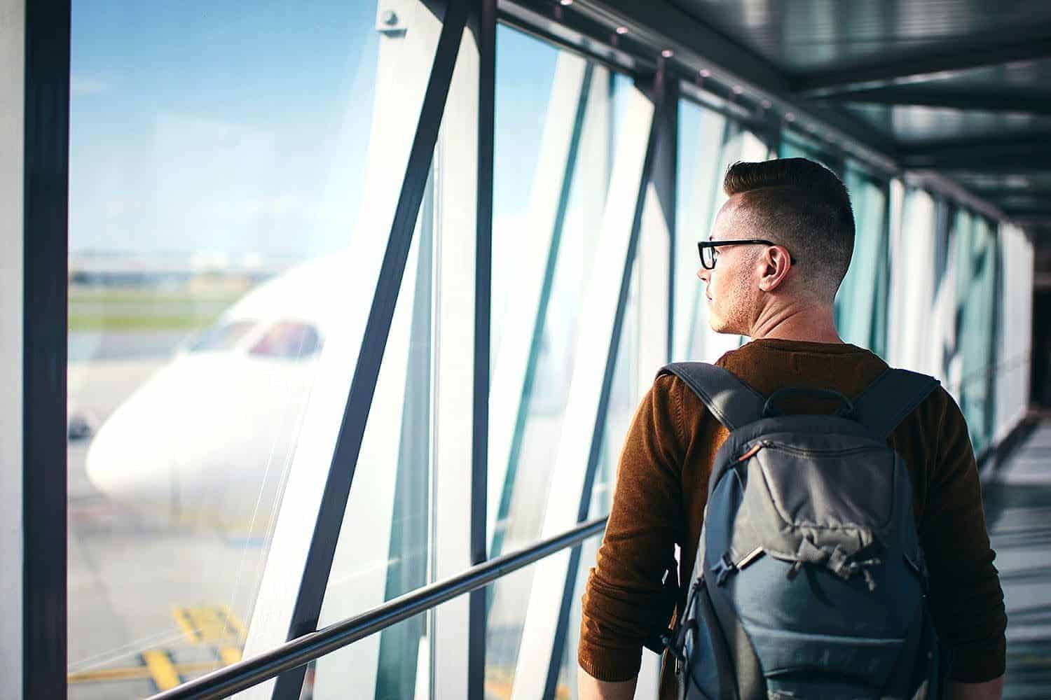 A man walking to his flight booked through the Corporate Travel Loyalty Program.