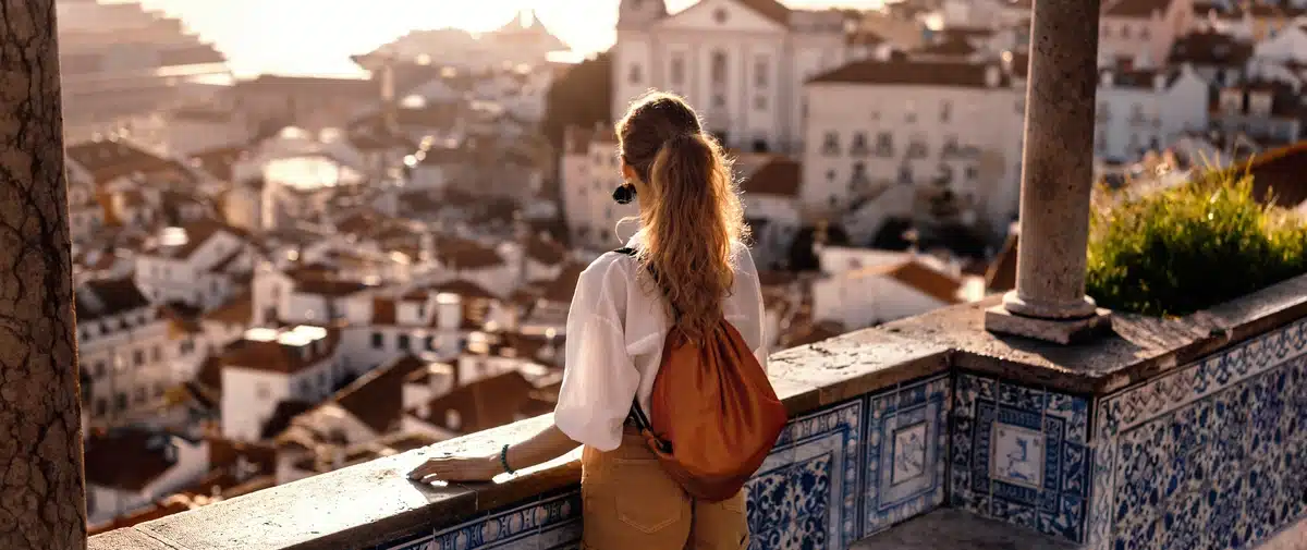Woman overlooking European city with cruise ship in background