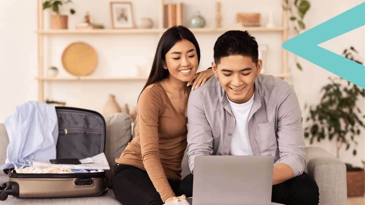 Couple Sitting At Home Using Laptop Booking Travel Tour with Loyalty Rewards.