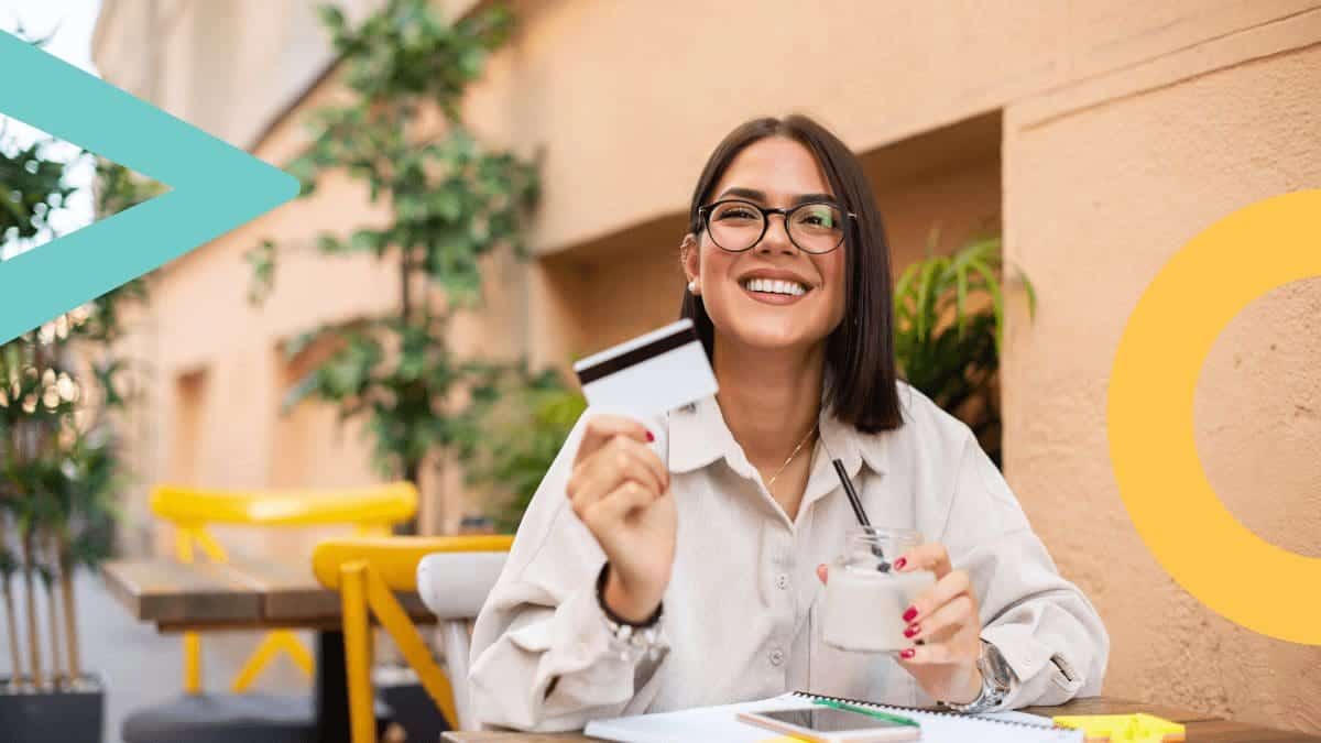 woman holding a card up with a big smile