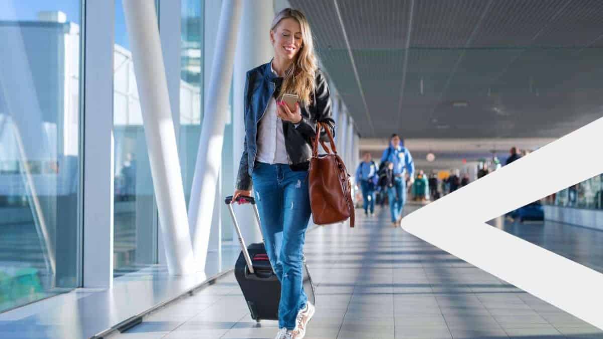 Women walking through the airport on a flight booked through a travel loyalty program.