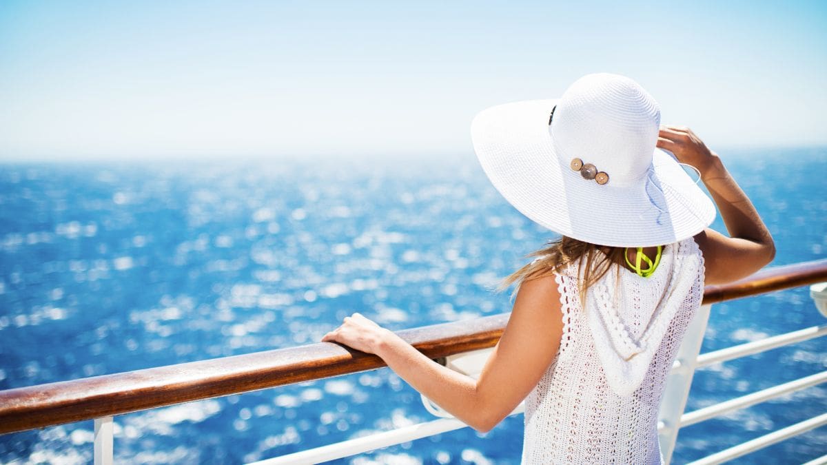 A woman standing on a cruise available through diversify travel rewards programs.