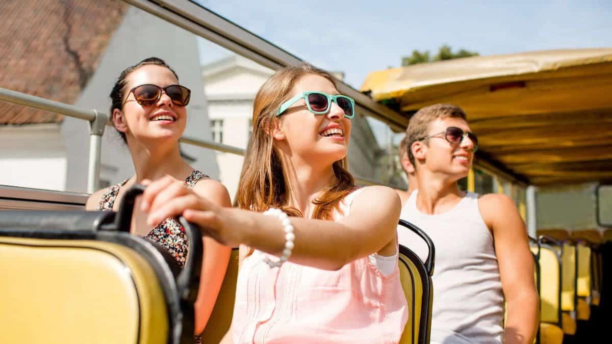 A group of travelers on a tour bus booked from a travel membership program.