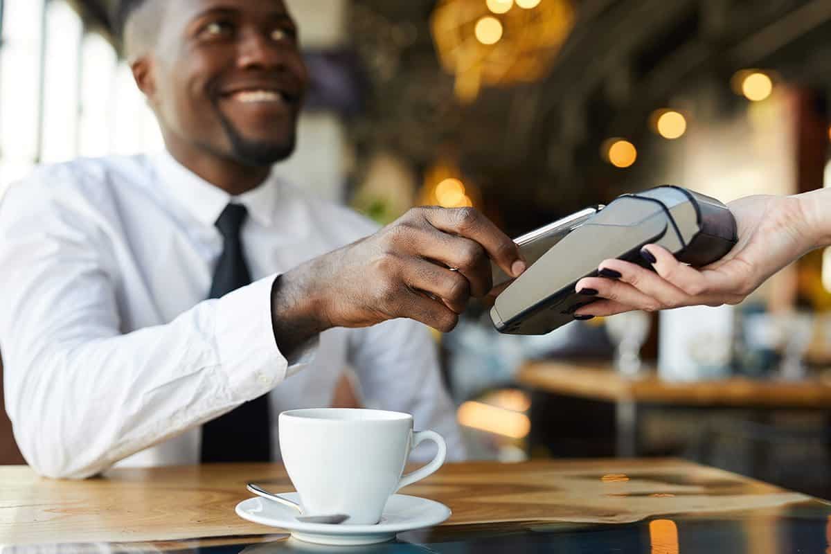 A man making-contactless-payment-in-cafe