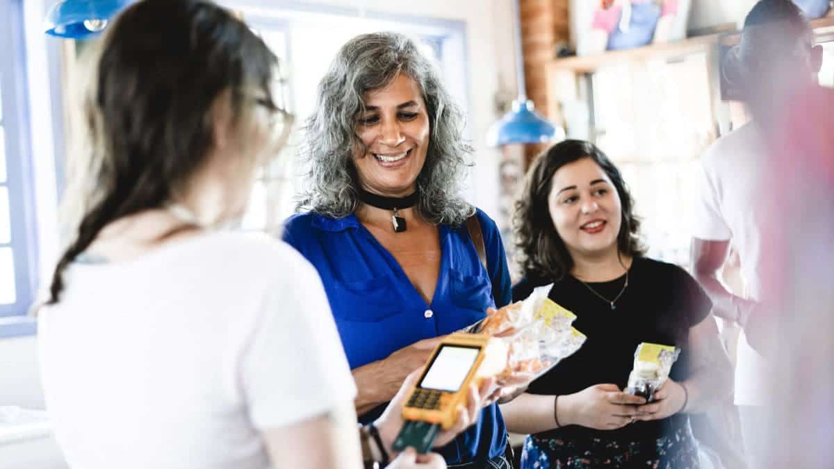 Two women shopping with points by an earn and burn loyalty program.