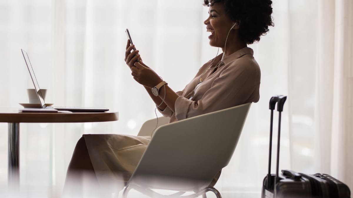 Woman sitting in an airport lounge accessed through a tiered loyalty program.