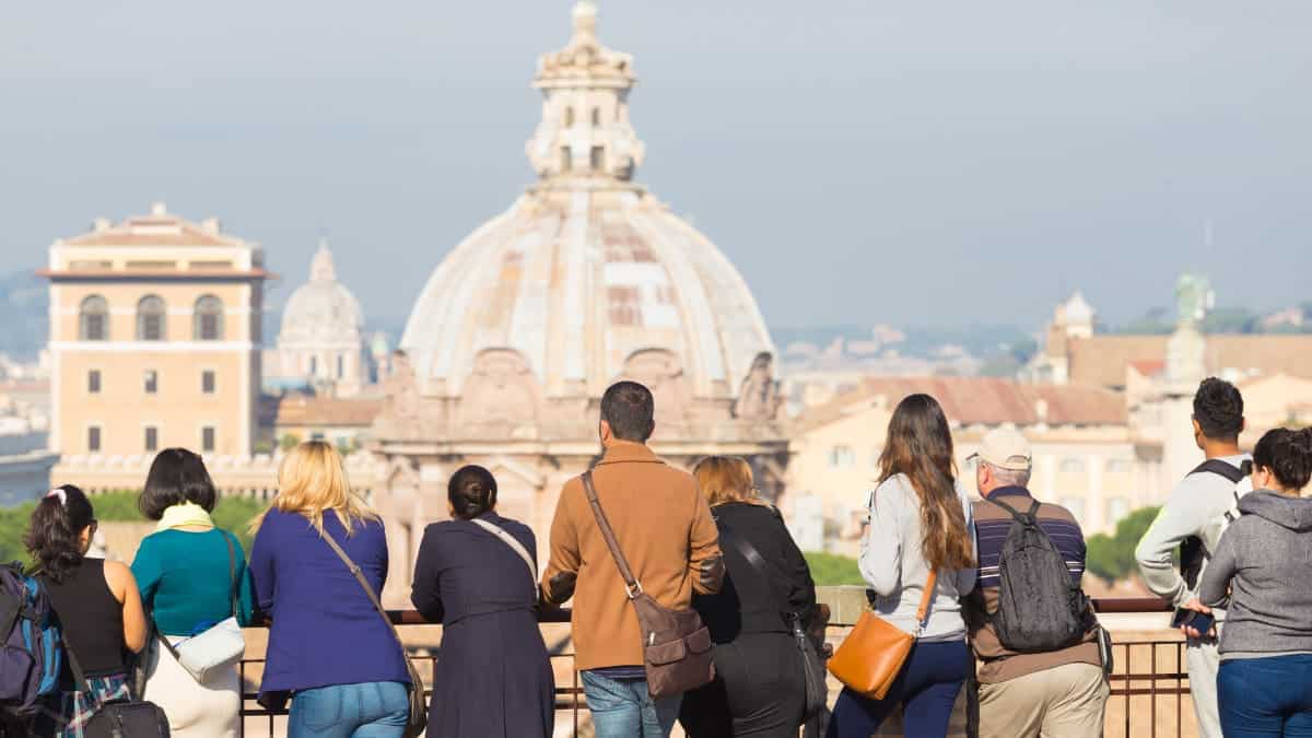 Group of tourists in Rome, Italy, looking at a monument.
