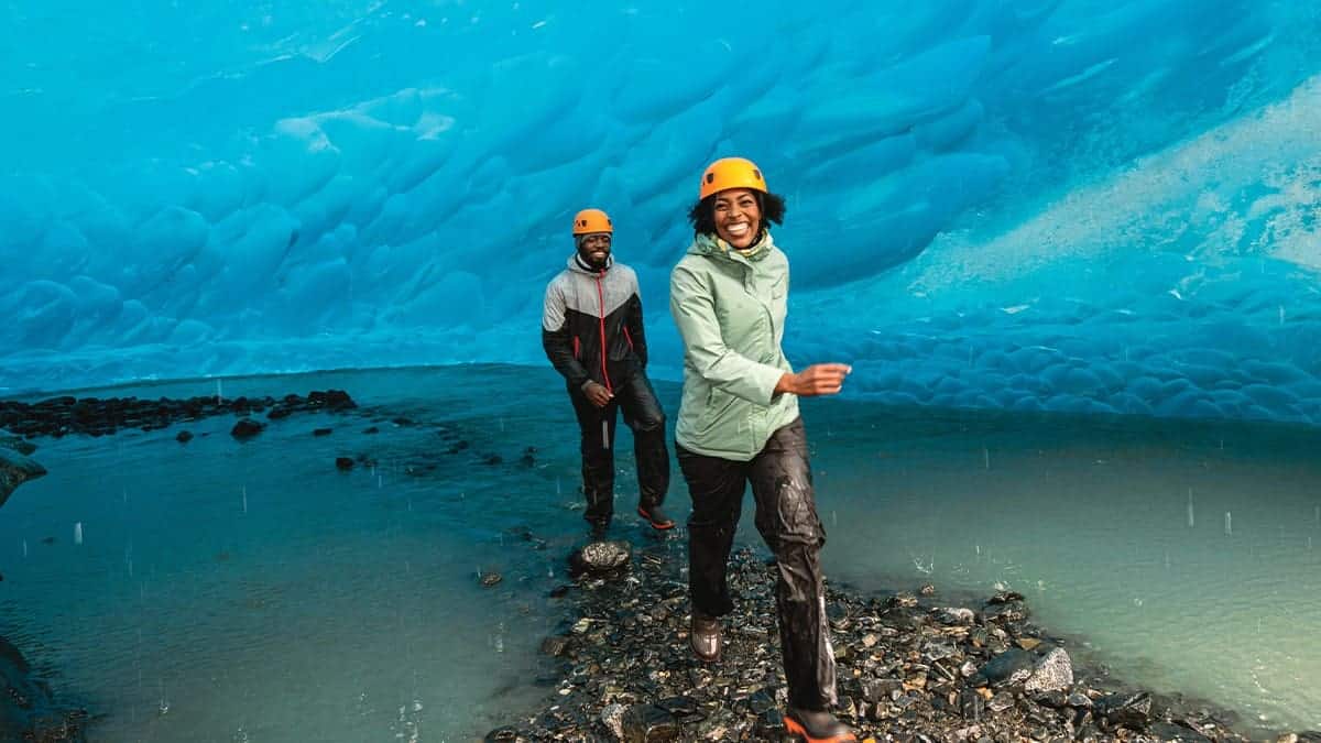 Travel consumers walking through a cave after being surveyed by arrivia about their 2024 travel plans and the role of travel rewards and loyalty programs