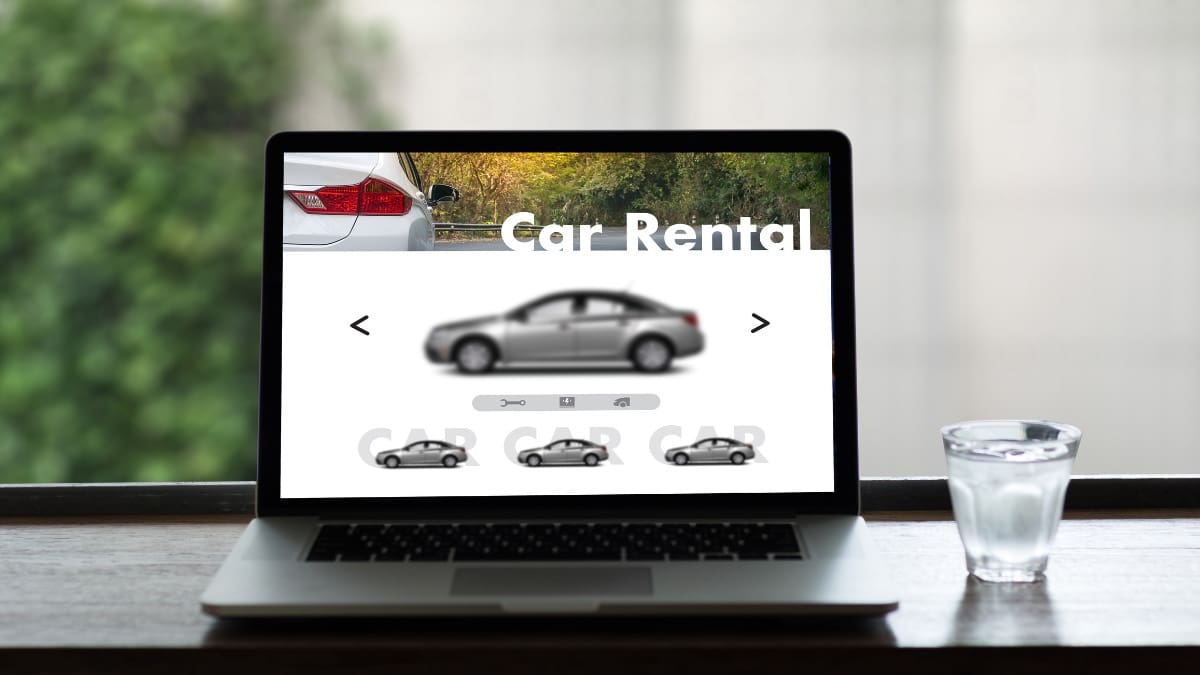 View of a rental car website on a laptop computer.