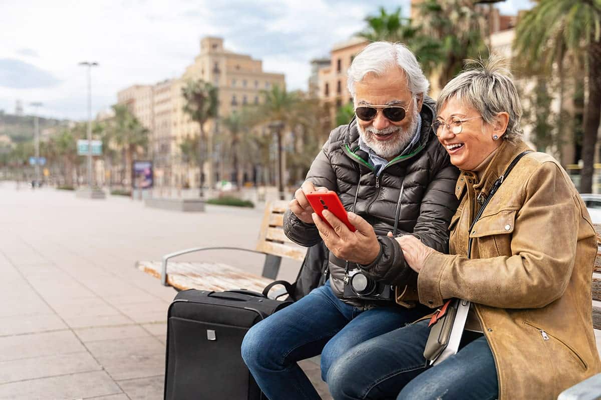 A couple checks their AI-generated travel itinerary after arriving at their destination.