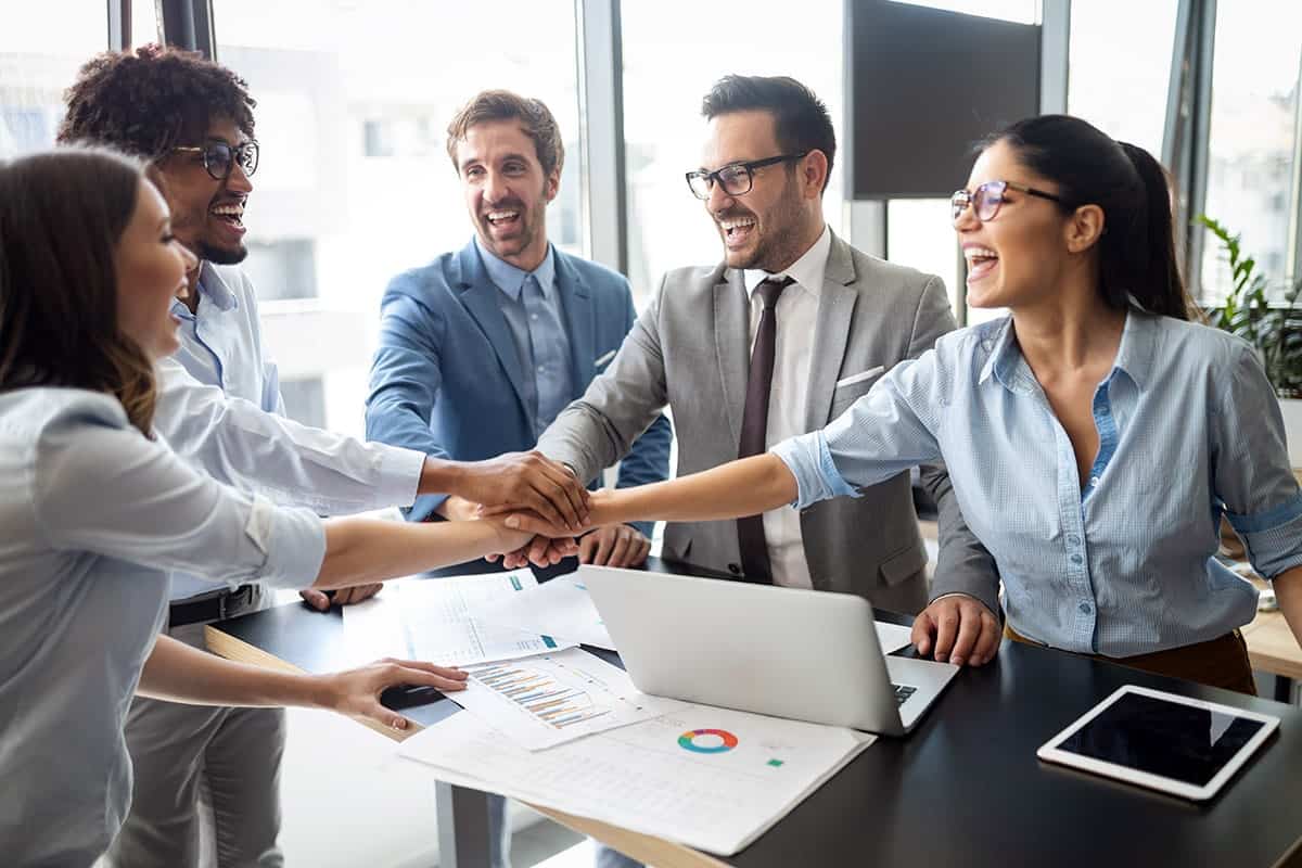 A group of travel industry professionals celebrates a newly formed strategic partnership to expand their loyalty ecosystem.