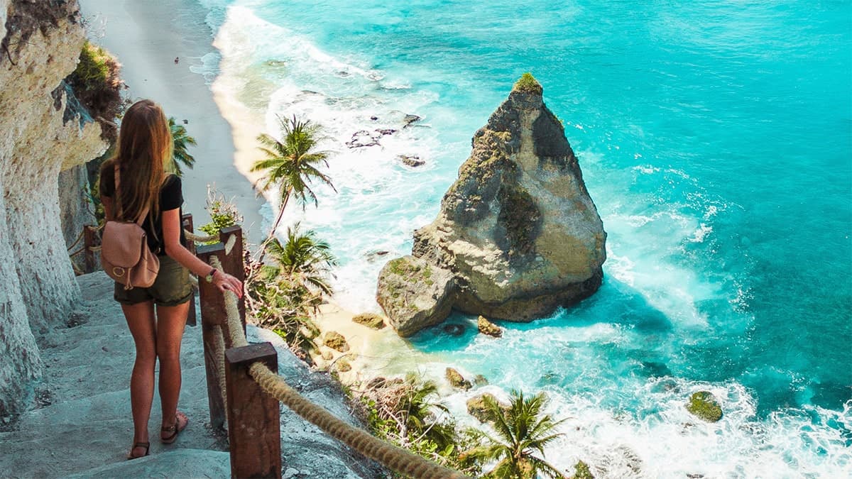 lady walking down stairs by the ocean