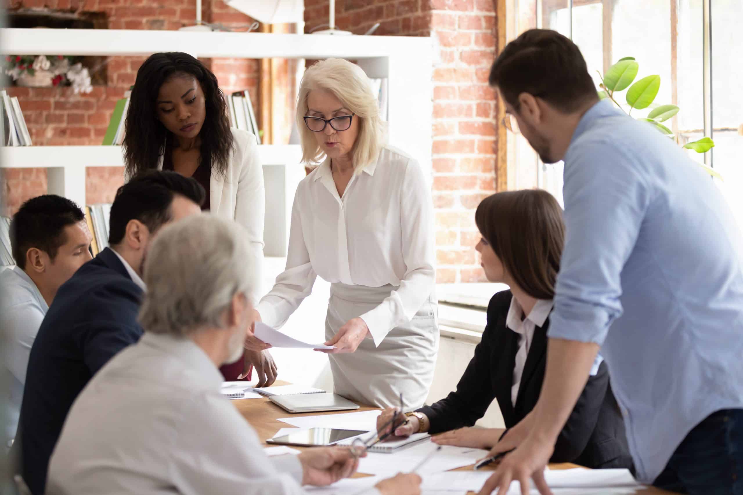 A team of professionals engaging in a meeting, discussing loyalty program regulation and compliance.