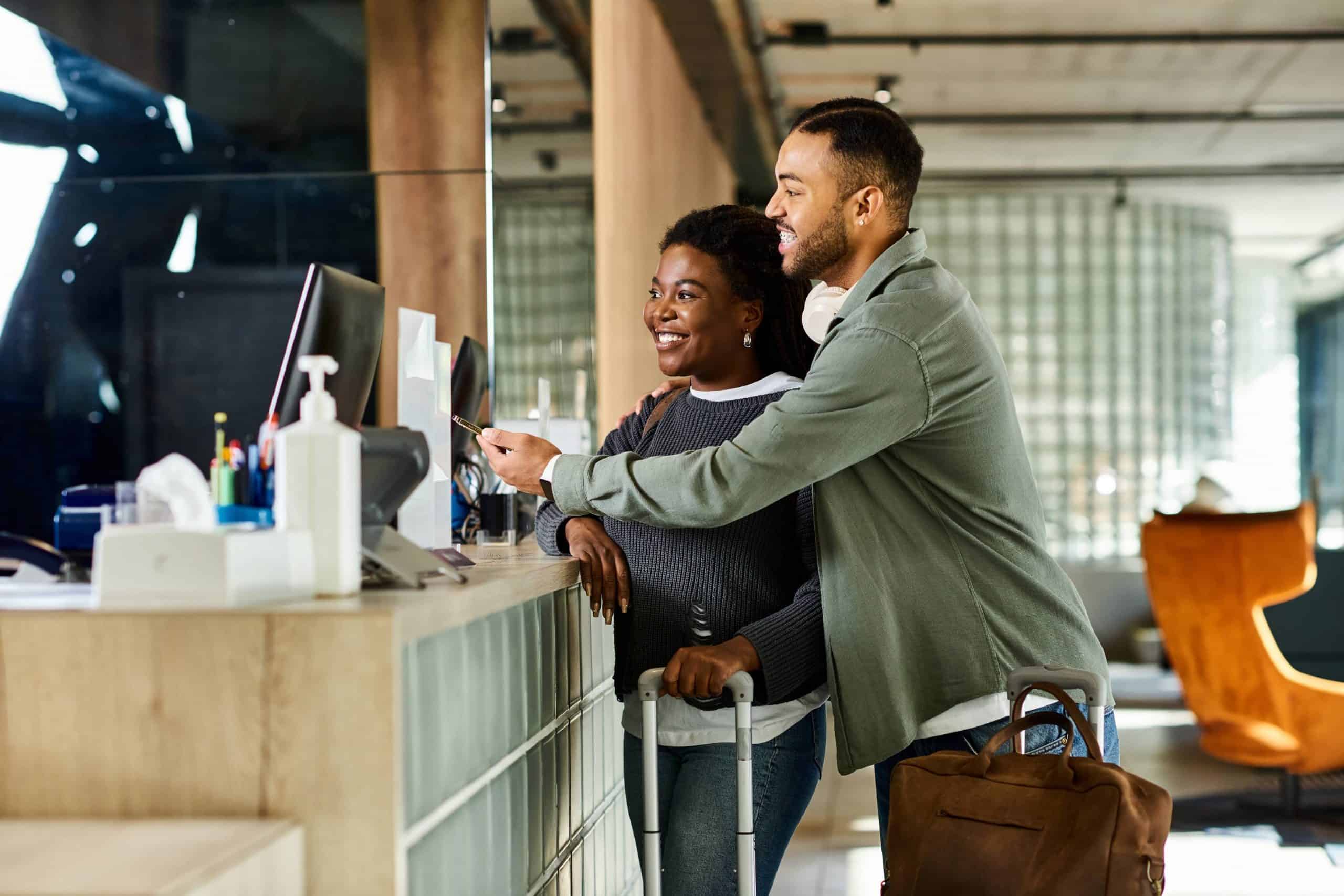 A couple checks into a hotel using digital integration from a travel loyalty program