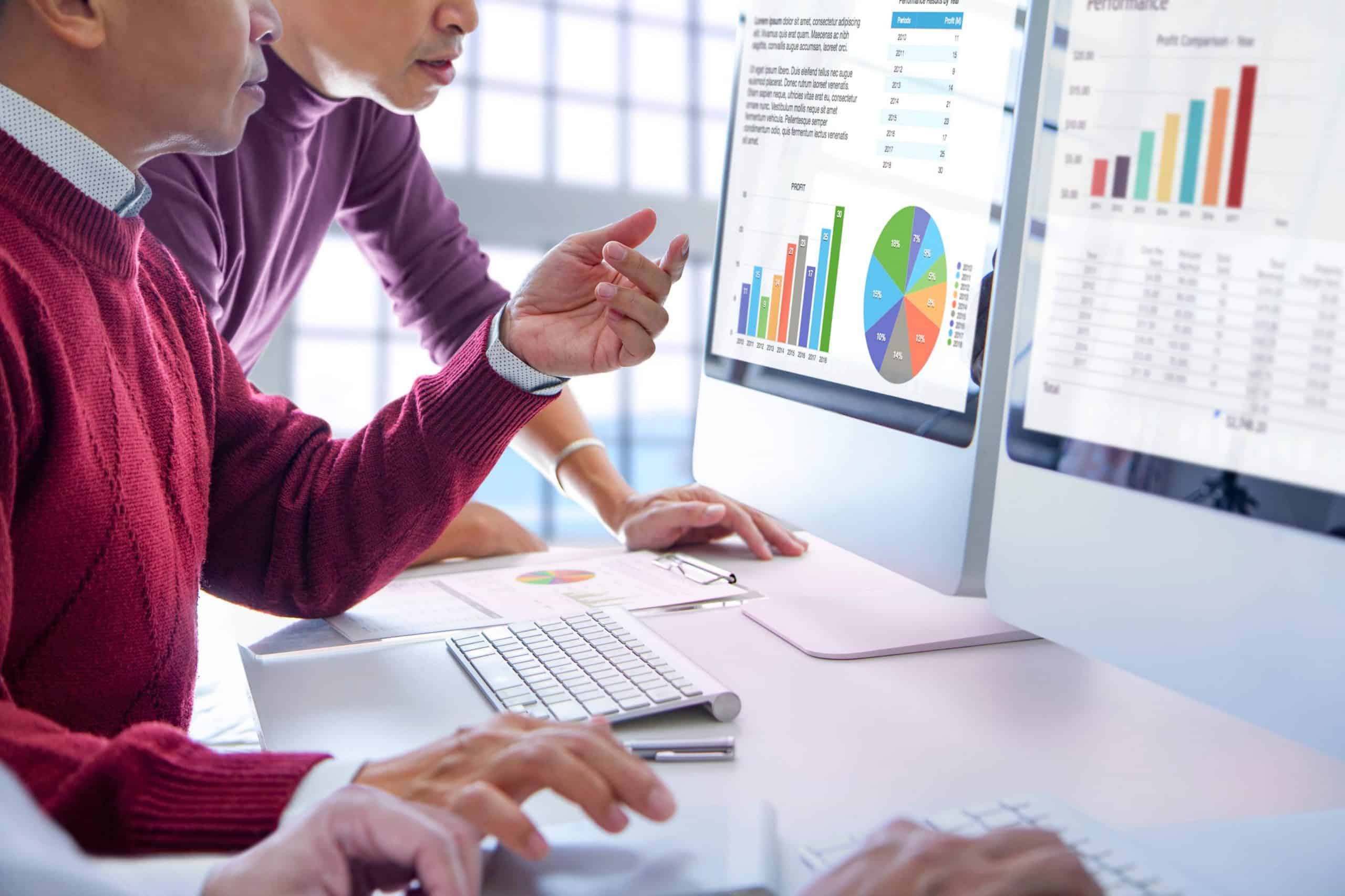 A team collaborates on performance metrics, using AI-driven loyalty program analytics to measure customer engagement and retention.