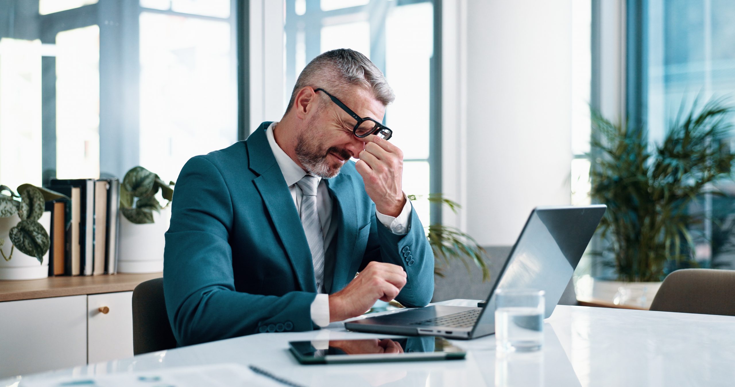 Stressed businessman at a laptop