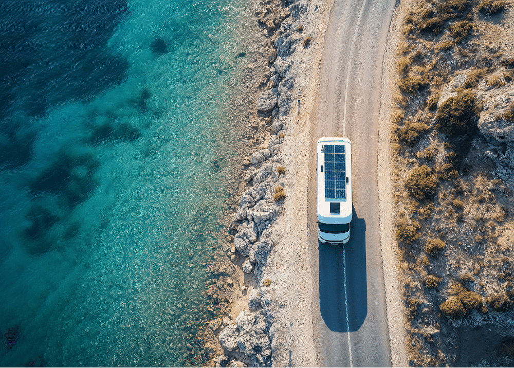 Solar panel van traveling along the ocean 
