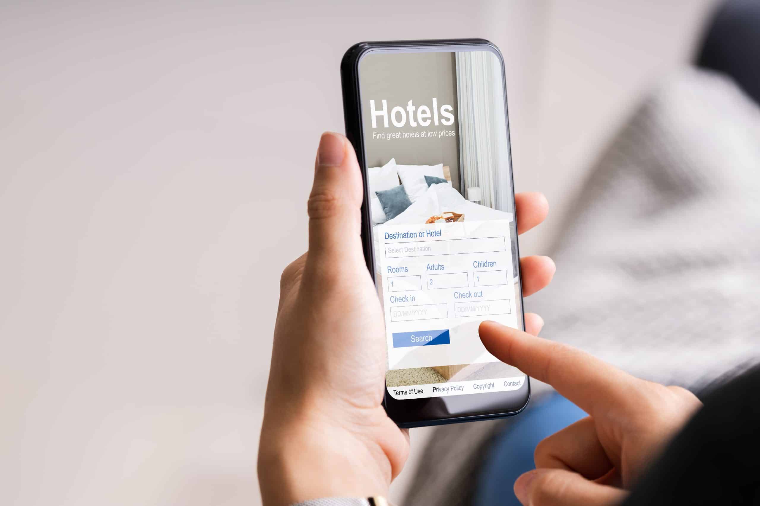 Person using a smartphone to book a hotel online
