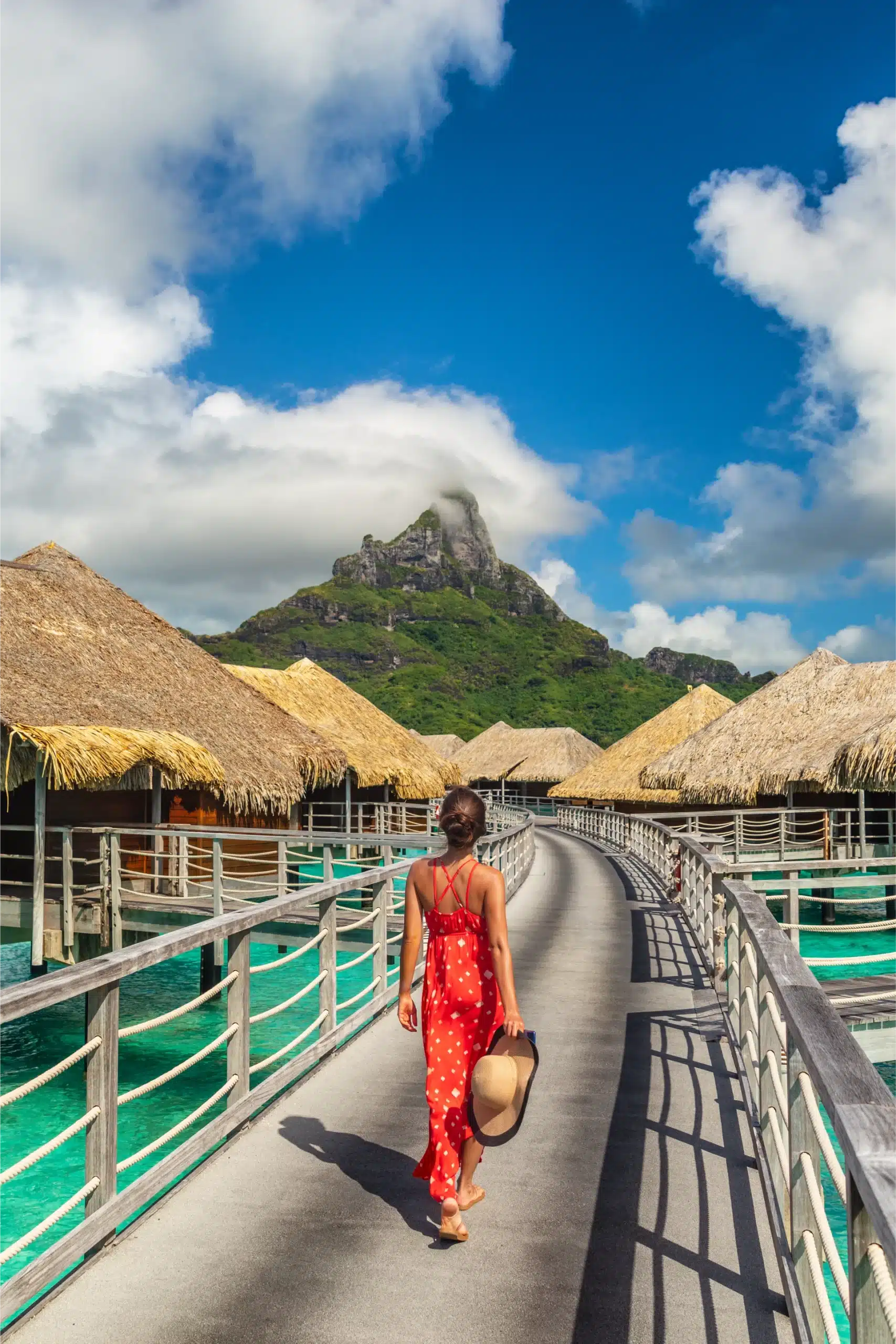 woman walking down a boardwalk in the ocean