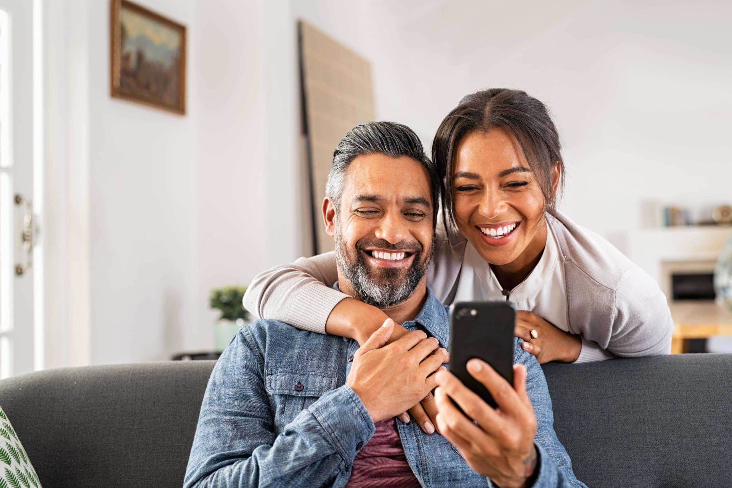 Customers using a smartphone to view rewards in a digital loyalty program